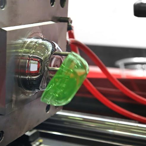 Finished part being ejected from mold. Image Credit: Shutterstock.com/sspopov