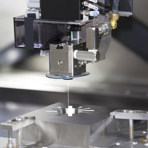 CNC wire cut machine making high-precision molded parts.  Image Credit: Shutterstock.com/Aumm graphixphoto